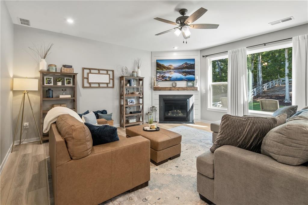 8530 Scenic Ridge Way Ball Ground, GA 30107 - Photo 11 of 45 a living room with furniture a large window and a fireplace