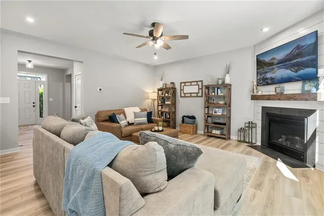 a living room with furniture a fireplace and a flat screen tv