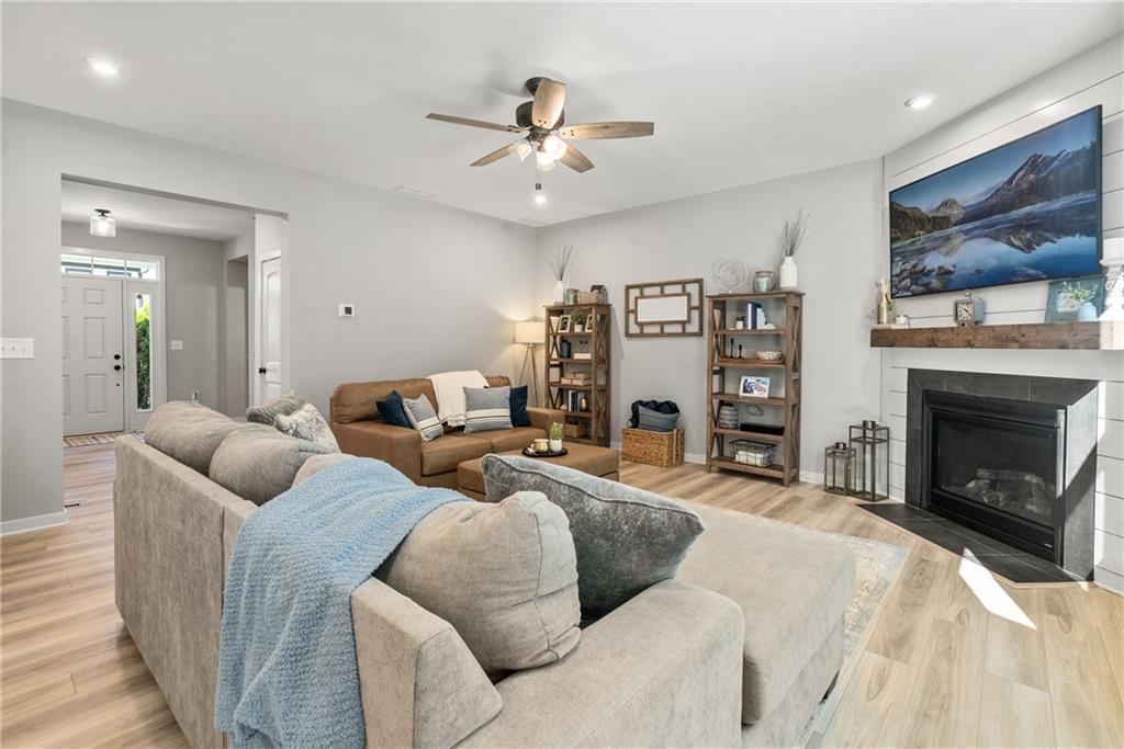 8530 Scenic Ridge Way Ball Ground, GA 30107 - Photo 12 of 45 a living room with furniture a fireplace and a flat screen tv