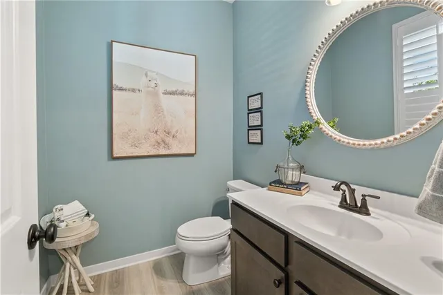a bathroom with a toilet a sink and mirror