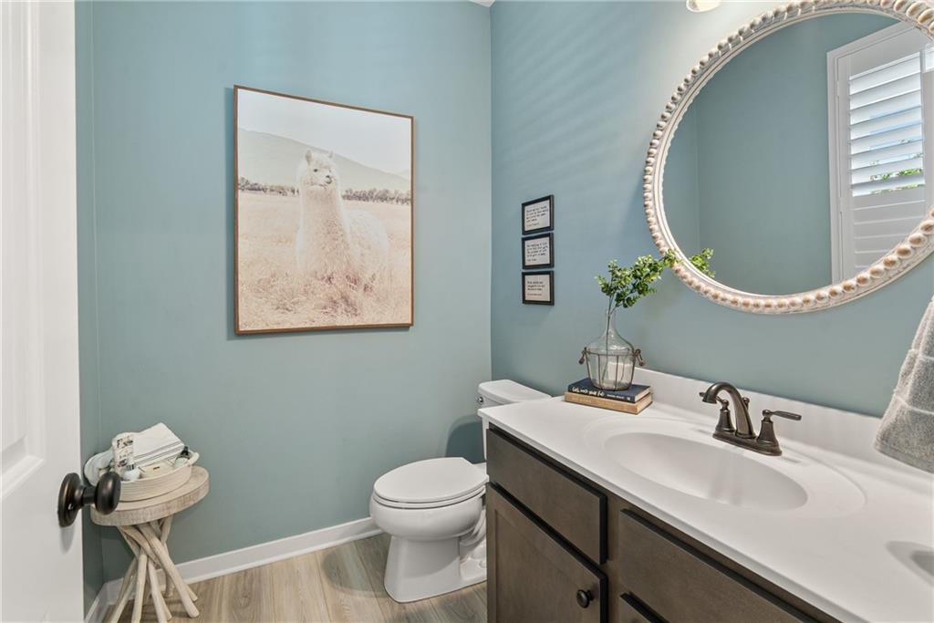 8530 Scenic Ridge Way Ball Ground, GA 30107 - Photo 15 of 45 a bathroom with a toilet a sink and mirror