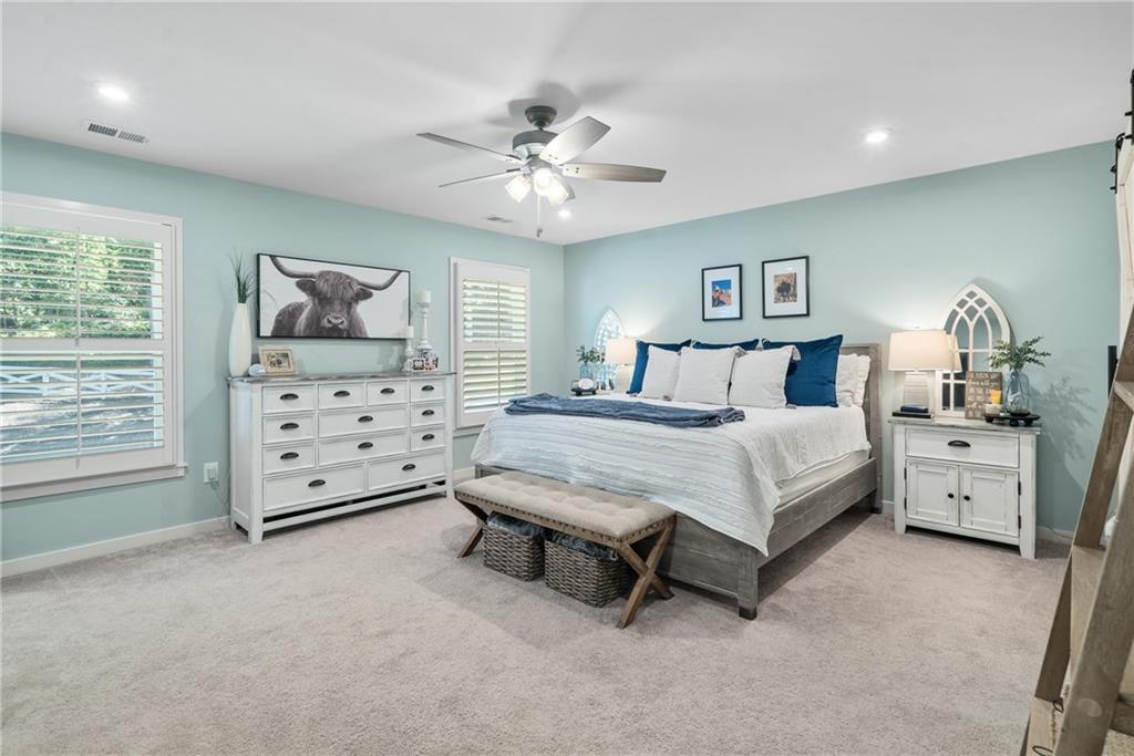 8530 Scenic Ridge Way Ball Ground, GA 30107 - Photo 16 of 45 a bedroom with a bed and a chandelier