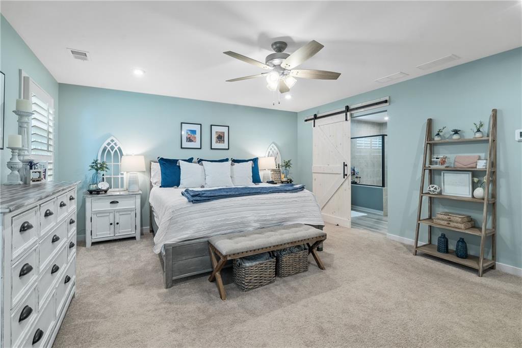 8530 Scenic Ridge Way Ball Ground, GA 30107 - Photo 18 of 45 a bedroom with furniture and a chandelier