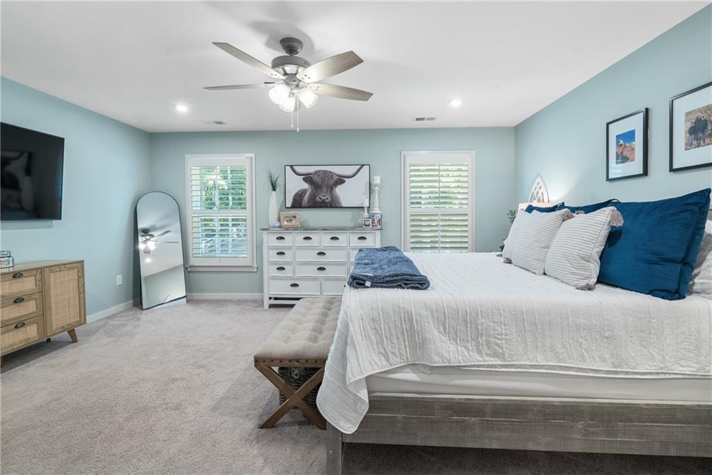 8530 Scenic Ridge Way Ball Ground, GA 30107 - Photo 19 of 45 a bedroom with a bed and a television on the dresser