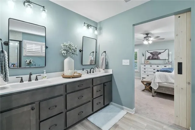 a en suite bathroom with double sink and a mirror