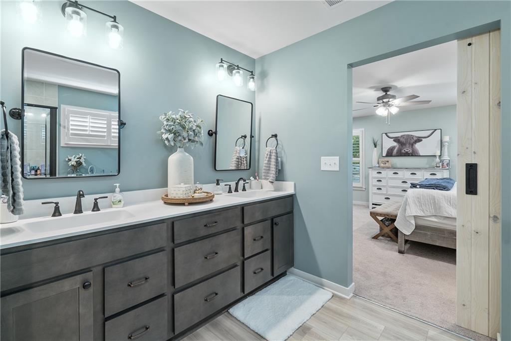 8530 Scenic Ridge Way Ball Ground, GA 30107 - Photo 20 of 45 a en suite bathroom with double sink and a mirror