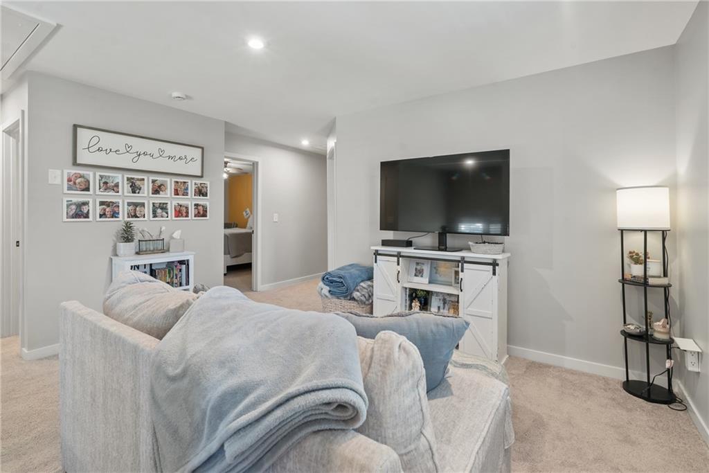 8530 Scenic Ridge Way Ball Ground, GA 30107 - Photo 25 of 45 a living room with furniture and a flat screen tv