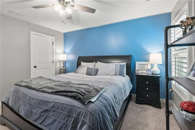 a bedroom with a bed and a lamp