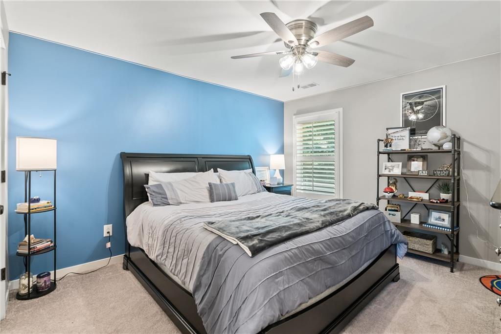 8530 Scenic Ridge Way Ball Ground, GA 30107 - Photo 27 of 45 a bedroom with a bed furniture and a chandelier