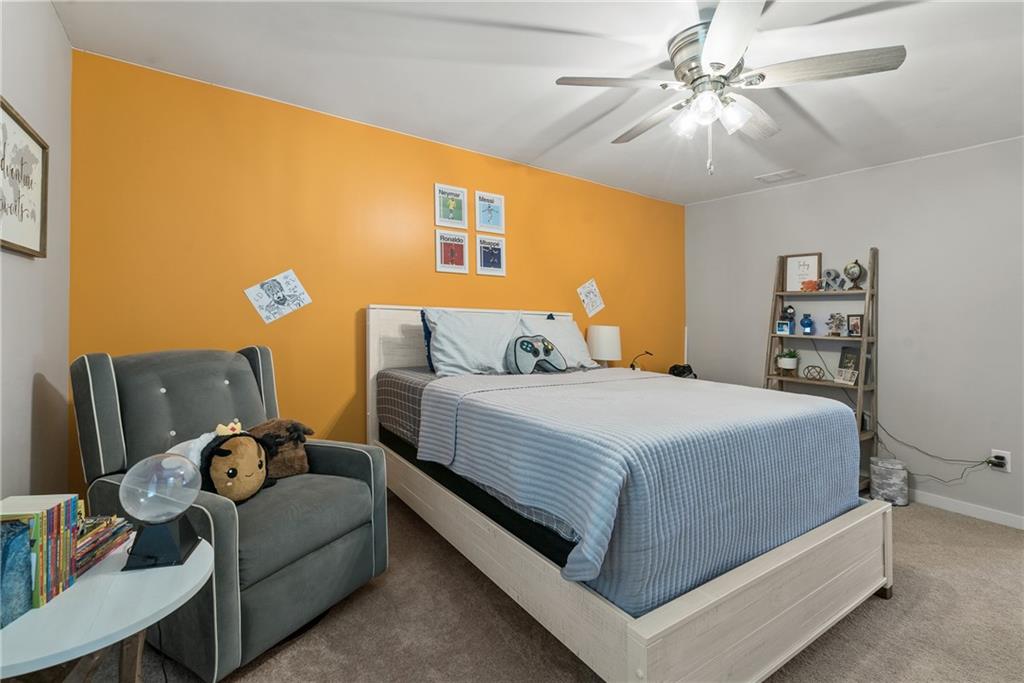 8530 Scenic Ridge Way Ball Ground, GA 30107 - Photo 28 of 45 a bedroom with a bed and a chandelier