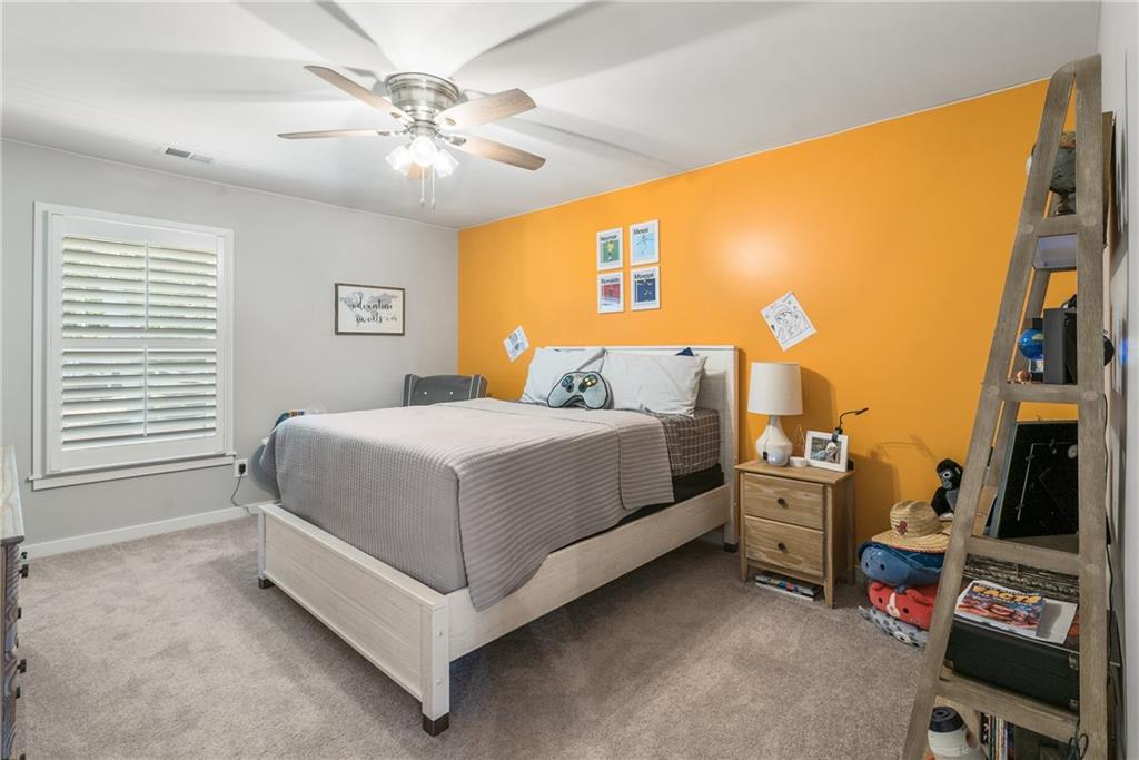 8530 Scenic Ridge Way Ball Ground, GA 30107 - Photo 29 of 45 a bedroom with bed and a chandelier