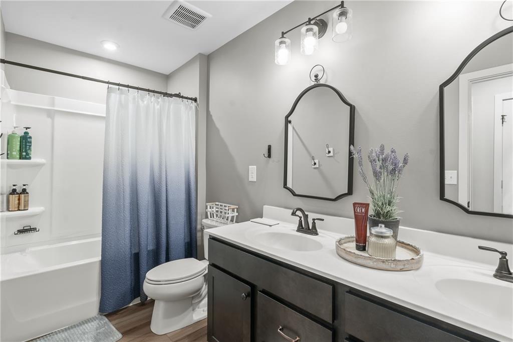 8530 Scenic Ridge Way Ball Ground, GA 30107 - Photo 32 of 45 a bathroom with a double vanity sink mirror and toilet
