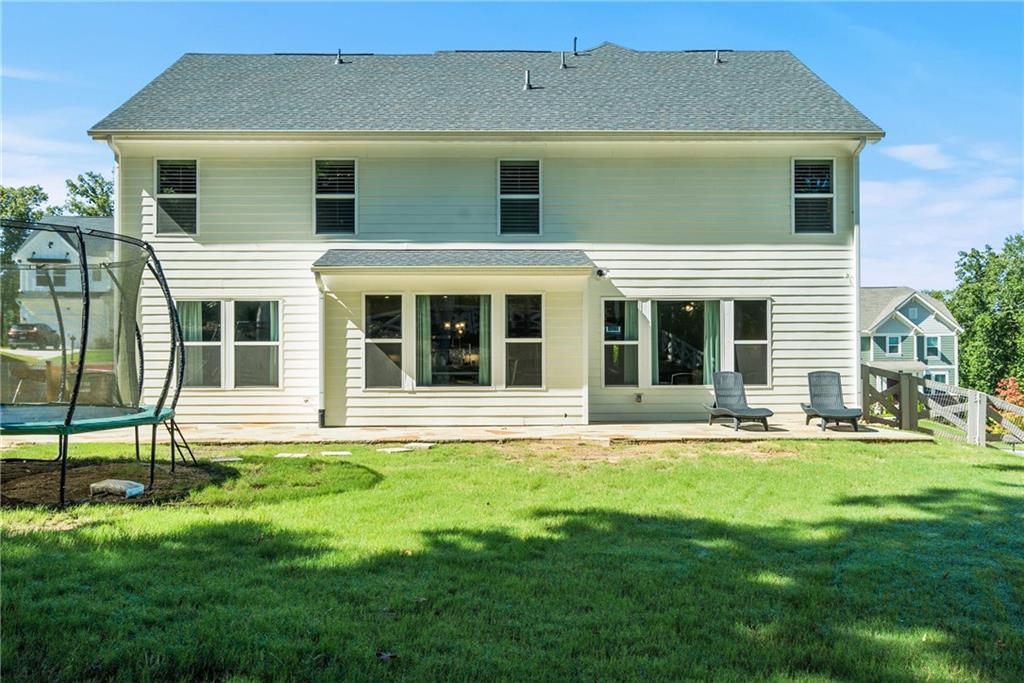 8530 Scenic Ridge Way Ball Ground, GA 30107 - Photo 34 of 45 front view of a house with a yard