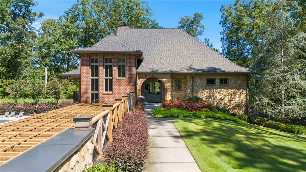 8530 Scenic Ridge Way Ball Ground, GA 30107 - Photo 37 of 45 a front view of a house with garden