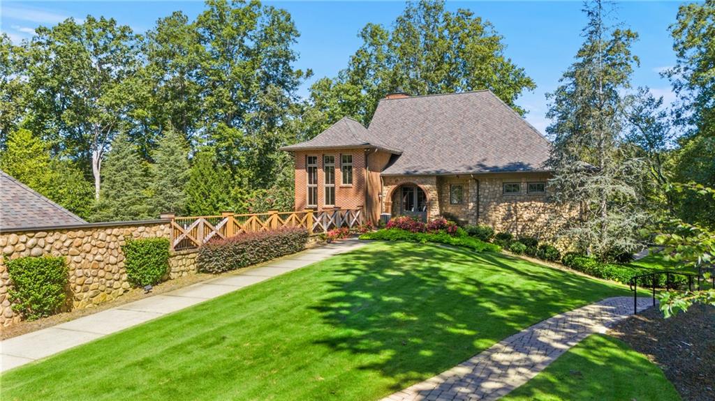 8530 Scenic Ridge Way Ball Ground, GA 30107 - Photo 38 of 45 a view of a house with a yard and plants