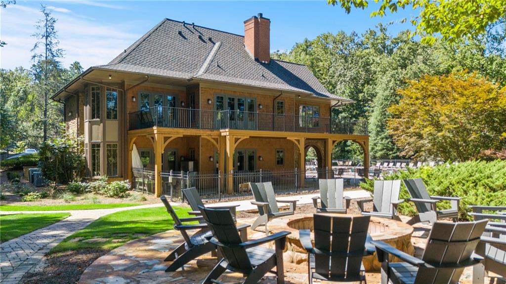 8530 Scenic Ridge Way Ball Ground, GA 30107 - Photo 39 of 45 a front view of house with a garden and patio