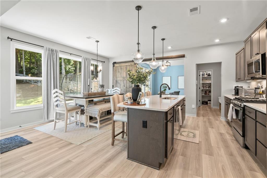 8530 Scenic Ridge Way Ball Ground, GA 30107 - Photo 5 of 45 a large kitchen with kitchen island a large island in it
