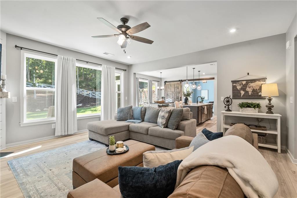 8530 Scenic Ridge Way Ball Ground, GA 30107 - Photo 10 of 45 a living room with furniture ceiling fan and a window