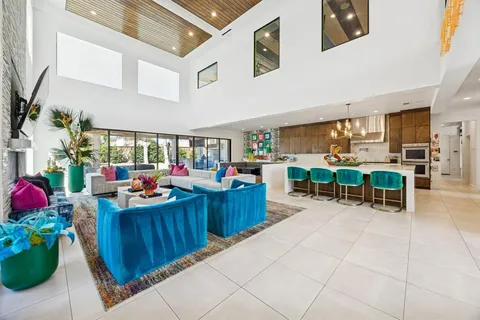 a kitchen with stainless steel appliances a kitchen island a table and chairs