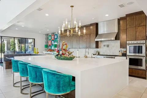 a kitchen with stainless steel appliances a stove a microwave and a refrigerator