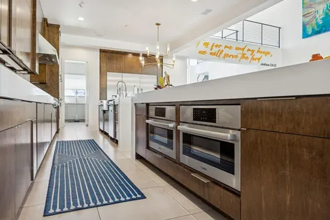 a kitchen with stainless steel appliances granite countertop a sink a stove and a refrigerator