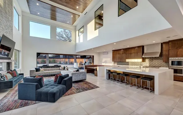 a living room with stainless steel appliances furniture a kitchen view and a kitchen view