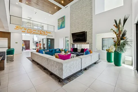 a spacious bedroom with a bed and glass couch