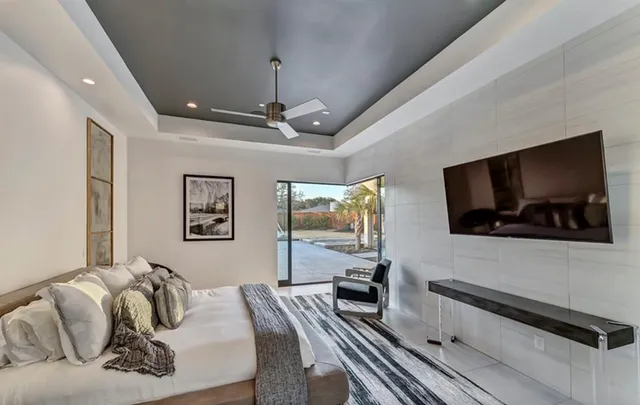 a spacious bedroom with a bed and wooden floor