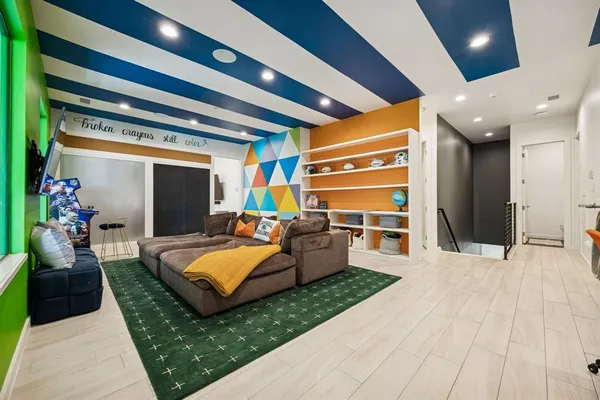 a living room with furniture and a kitchen view