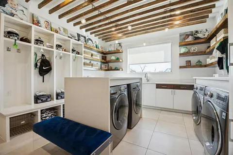 a living room with furniture and a kitchen view