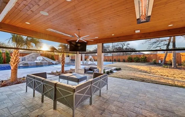 a view of a swimming pool with a patio and a yard