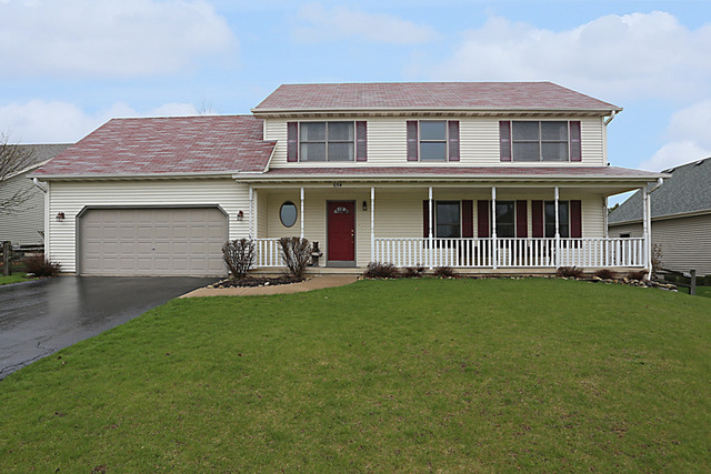 a front view of a house with a garden and porch