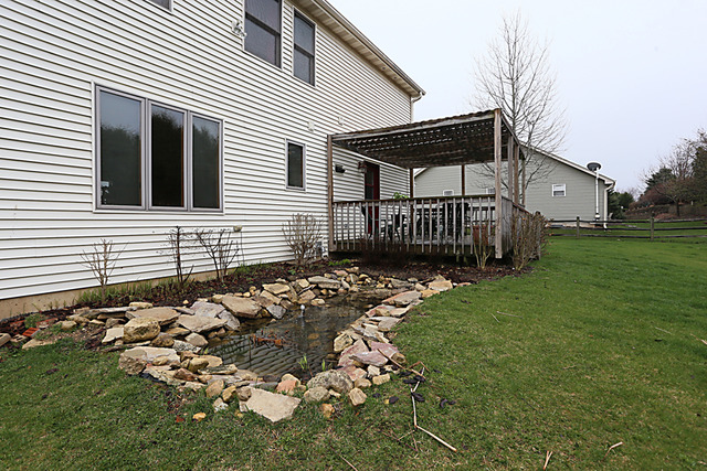 654 Ridge Drive Elburn, IL 60119 - Photo 21 of 25 a front view of a house with garden