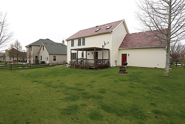 654 Ridge Drive Elburn, IL 60119 - Photo 25 of 25 a view of a house with a yard and sitting area