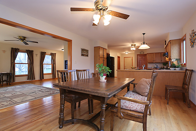 654 Ridge Drive Elburn, IL 60119 - Photo 8 of 25 a dining room with furniture a chandelier and wooden floor