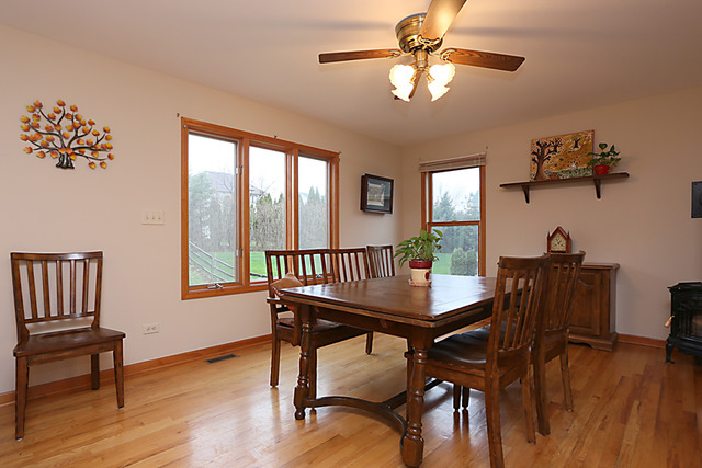654 Ridge Drive Elburn, IL 60119 - Photo 9 of 25 a view of a dining room with furniture window and wooden floor