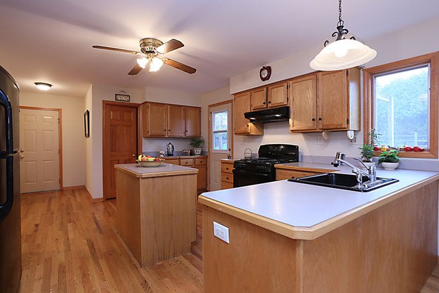 654 Ridge Drive Elburn, IL 60119 - Photo 10 of 25 a kitchen with a sink stainless steel appliances and cabinets