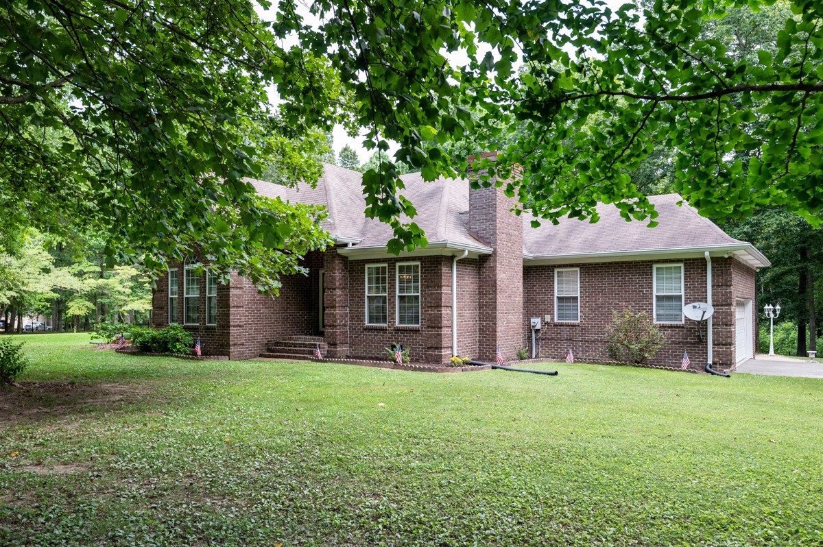734 Keytown Road Portland, TN 37148 - Photo 2 of 49 a front view of a house with a garden and trees