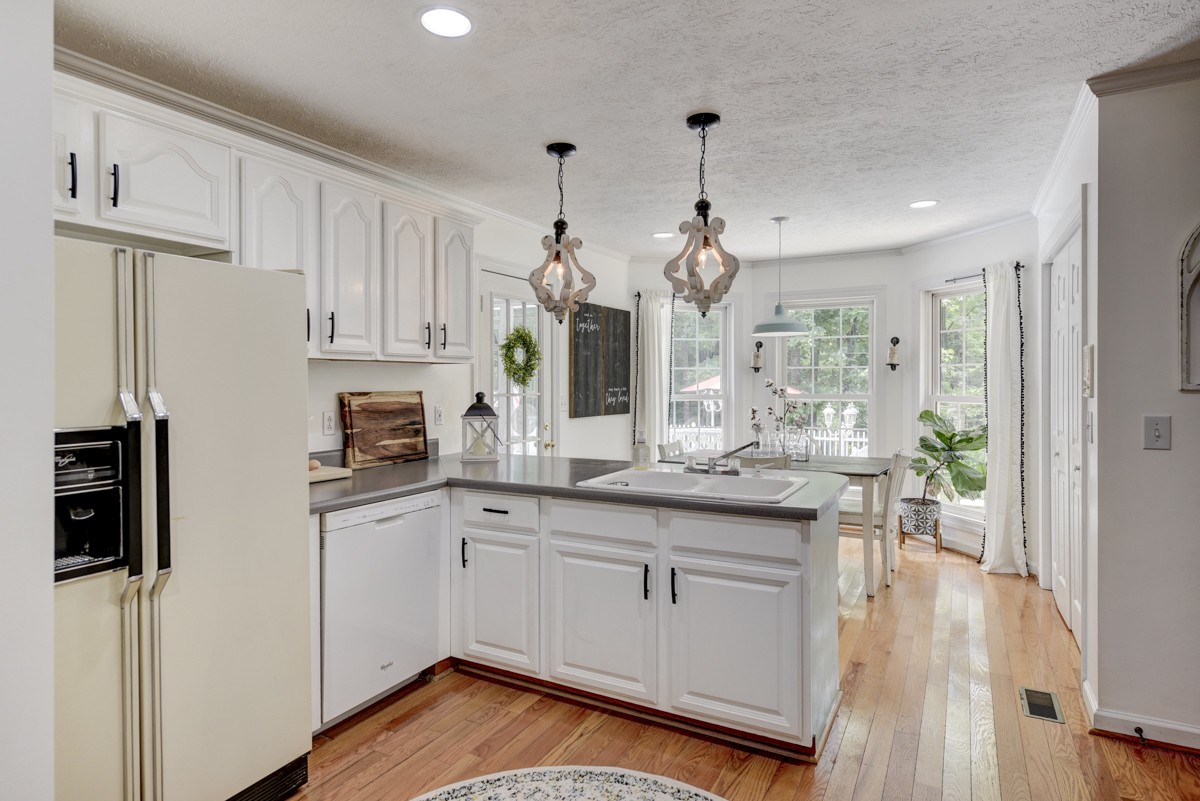 734 Keytown Road Portland, TN 37148 - Photo 15 of 49 a kitchen with stainless steel appliances granite countertop a refrigerator a sink dishwasher a stove and white cabinets with wooden floor