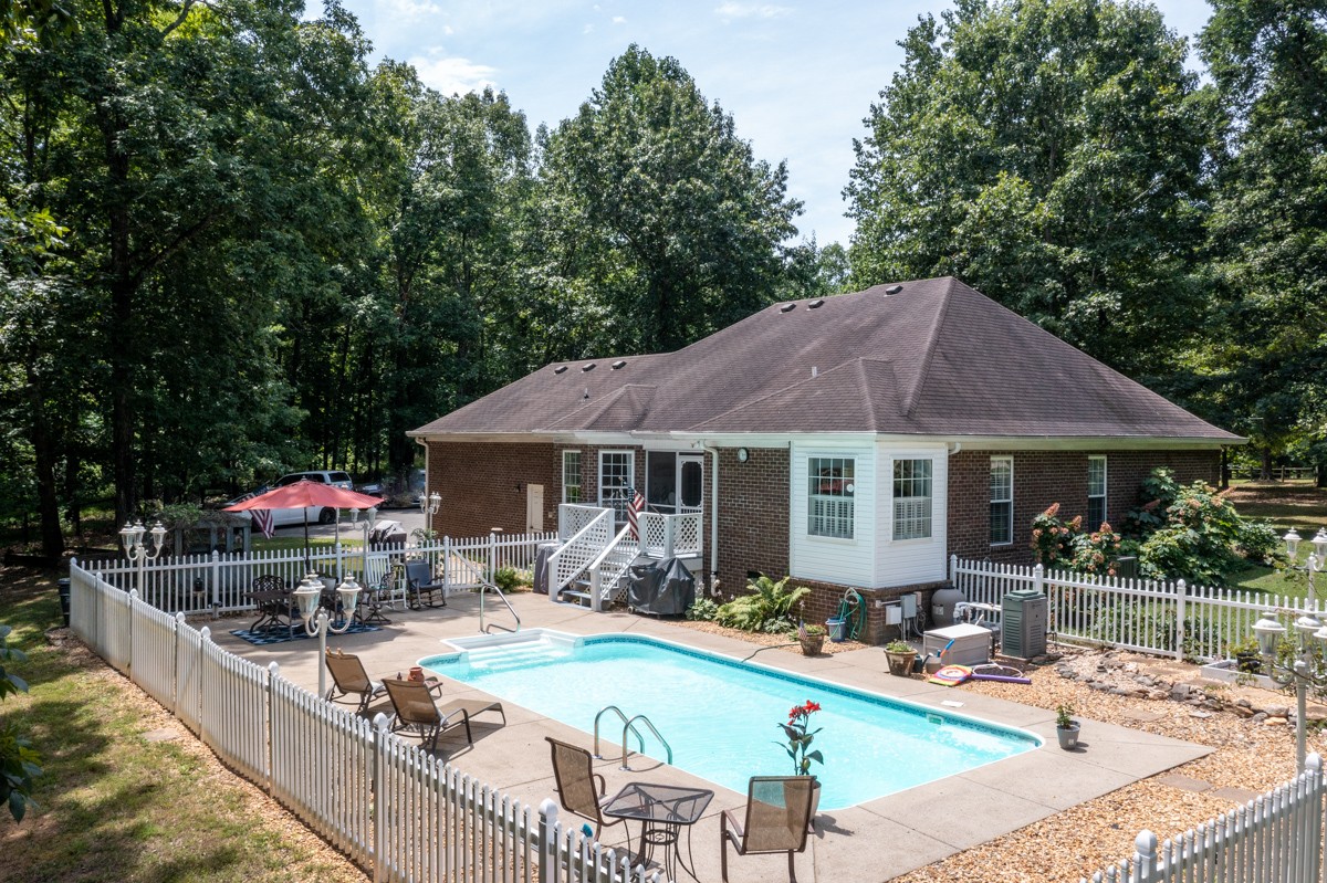 734 Keytown Road Portland, TN 37148 - Photo 3 of 49 a swimming pool view with a seating space and a garden view