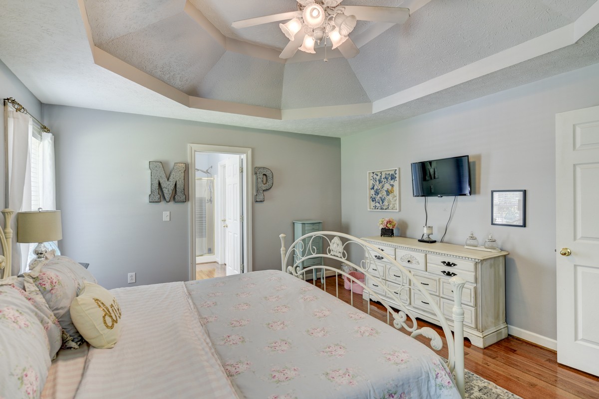734 Keytown Road Portland, TN 37148 - Photo 21 of 49 a bedroom with a bed and a flat tv screen on dresser