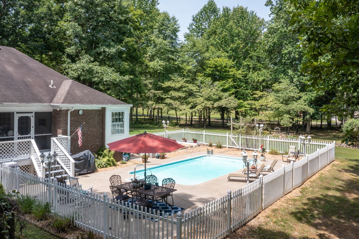 734 Keytown Road Portland, TN 37148 - Photo 31 of 49 a view of a patio with chairs under an umbrella