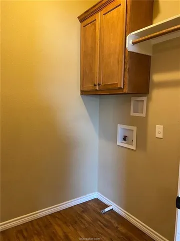 a view of small space with wooden floor and a window