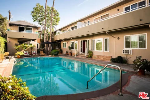 a view of a house with pool patio and a yard
