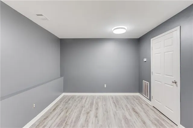 a white toilet sitting next to a shower