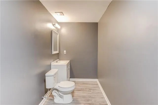 a balcony with wooden floor and trees in the background