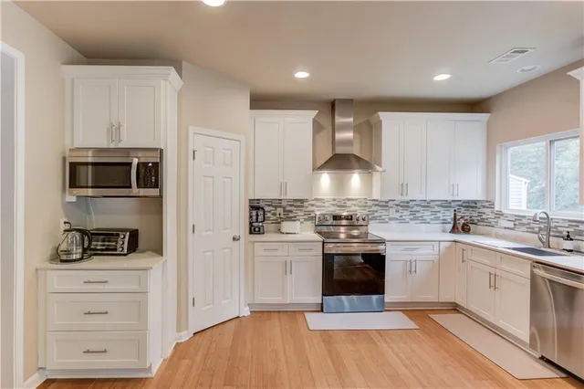 a kitchen with a stove a sink and a refrigerator