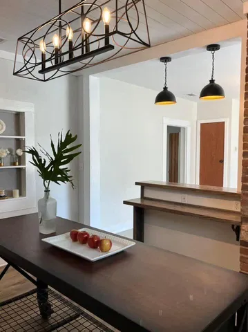 a table with a vase and flowers on it