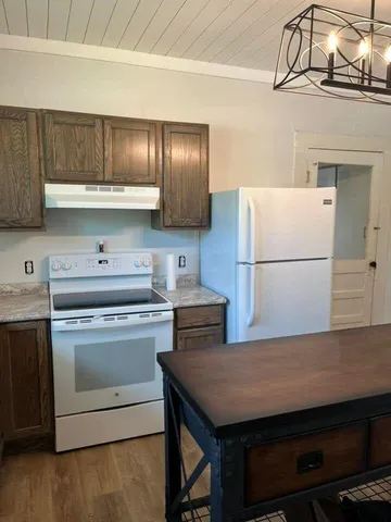 a kitchen with a stove and a refrigerator