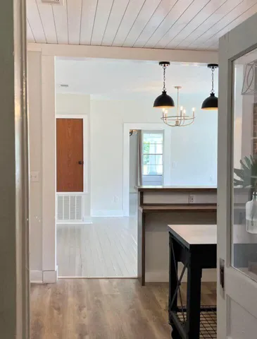 a hallway with windows and a fireplace